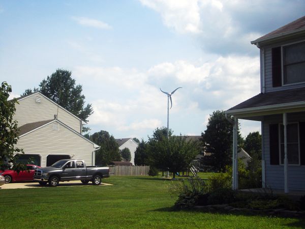 photo of a wind turbine in a residential community