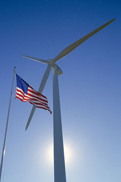 photo of a wind turbine with a flag