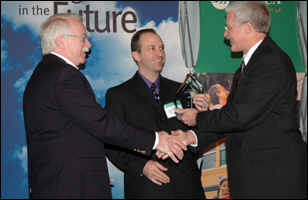 Steve Lindenberg (right), DOE, presents the Wind Cooperative of the Year Award to Bruce Giffin (left), general manager, and Sean Middleton (middle), engineer.