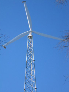A photo of a three-bladed wind turbine on a lattice tower. PIX16904