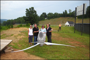 Photo of people getting ready to install a Skystream wind turbine. PIX18208